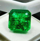 Close-up view of 7 carat certified Colombian emerald with emerald cut, glowing with natural green hue and placed neatly in a white display box.