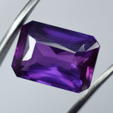 12.00 Carat Purple Tanzanite Gemstone Held by Gem Tool – Loupe Clean Emerald Cut
