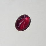 Red oval ruby gemstone with star-like sheen placed upright – 9.65 Ct natural asterism ruby