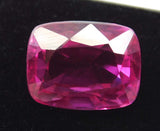 
Loose natural pink ruby 11.66 Ct in cushion cut positioned on black rod against white background – excellent cut grade

