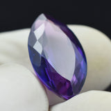 Purple Tanzanite 11.75 Ct Marquise Cut Loose Gemstone Held Between Fingers – Natural & Certified