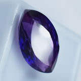 Certified 11.75 Ct Purple Tanzanite Loose Gemstone Marquise Shape Displayed on White Box

