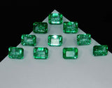 Triangle shape arrangement of Colombian green emeralds, clarity enhanced emerald cut stones