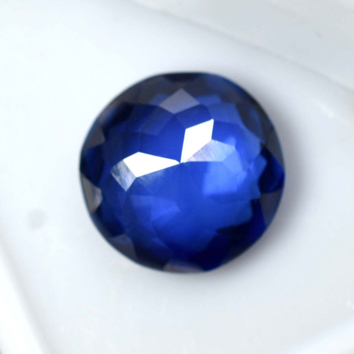 Loose Blue Tanzanite Round Gemstone Displayed on White Surface - 12.54 Ct Certified from Tanzania