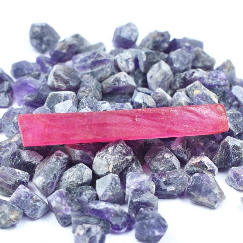 Red Ruby Rough gemstone under natural sunlight showing surface shine