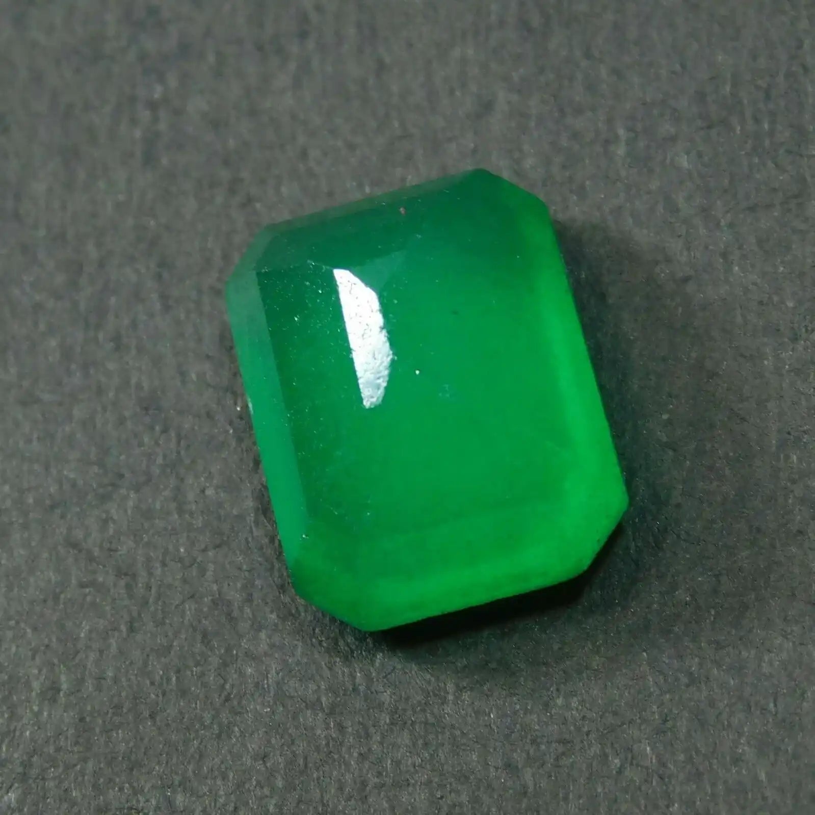Green gemstone on a dark gray background