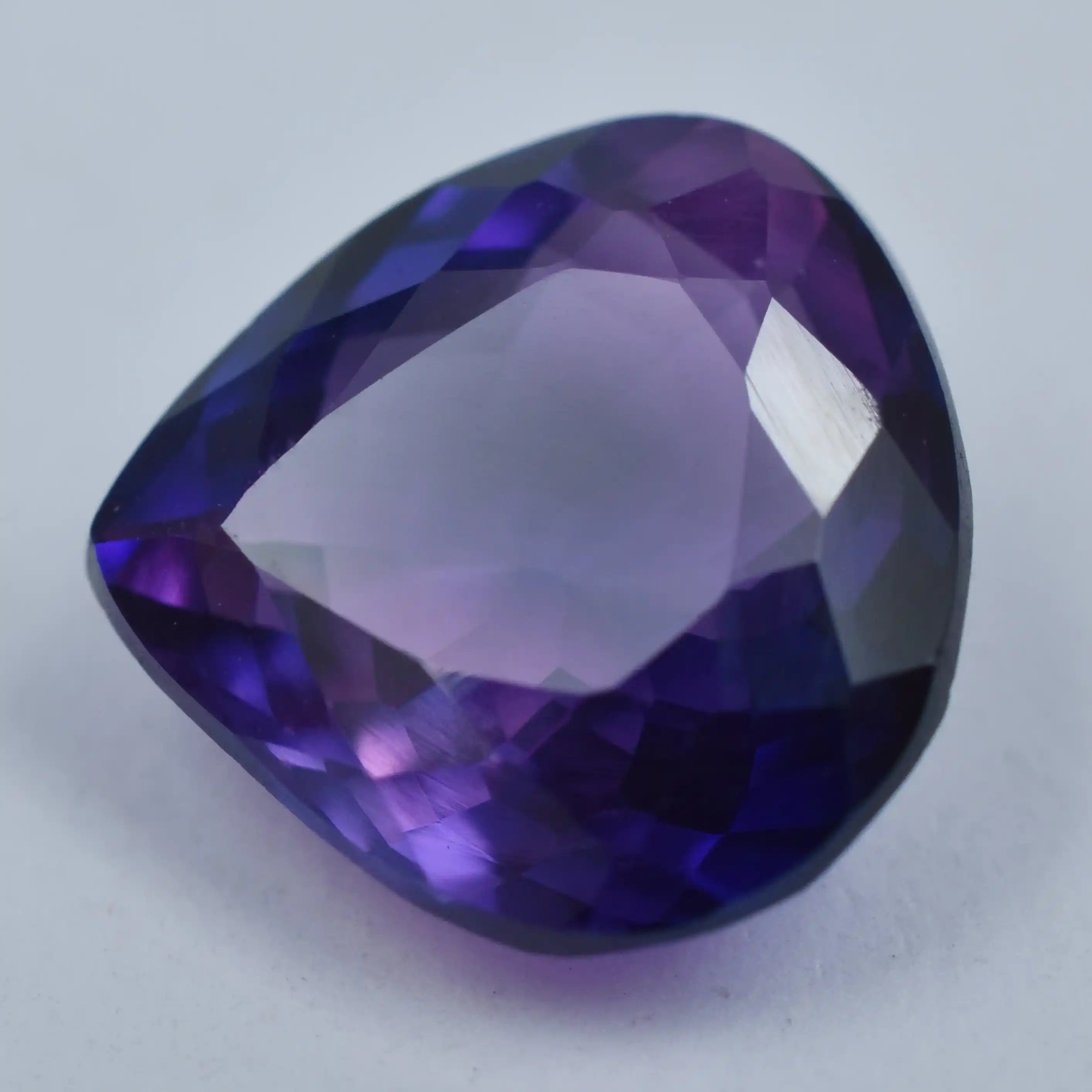 Natural purple gemstone with precision trillion faceted design, glowing crystal clarity.