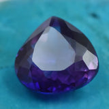 Luxury dark purple crystal gemstone with symmetrical facets and high glossy sparkle.