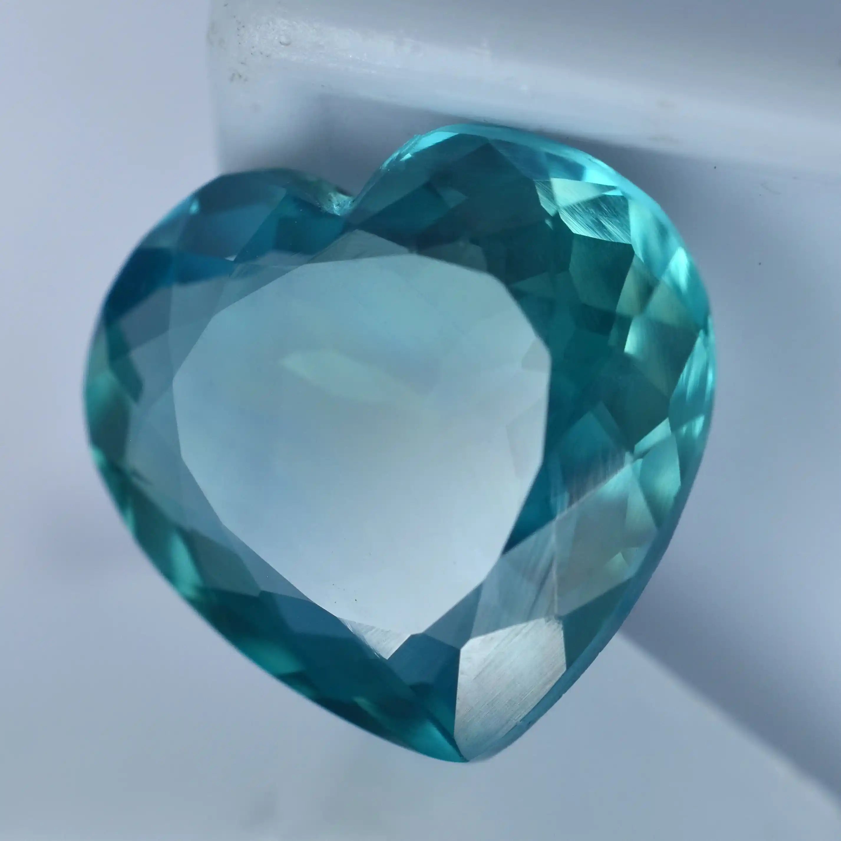 Heart-shaped blue gemstone on a white background