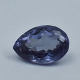 Faceted purple gemstone on a light gray background