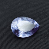 10.55 Carat Pear Cut Color-Change Alexandrite placed on black background showing clarity and depth