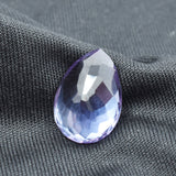 Vertical top view of pear cut 10.55 Ct Alexandrite on black background showcasing elegant symmetry