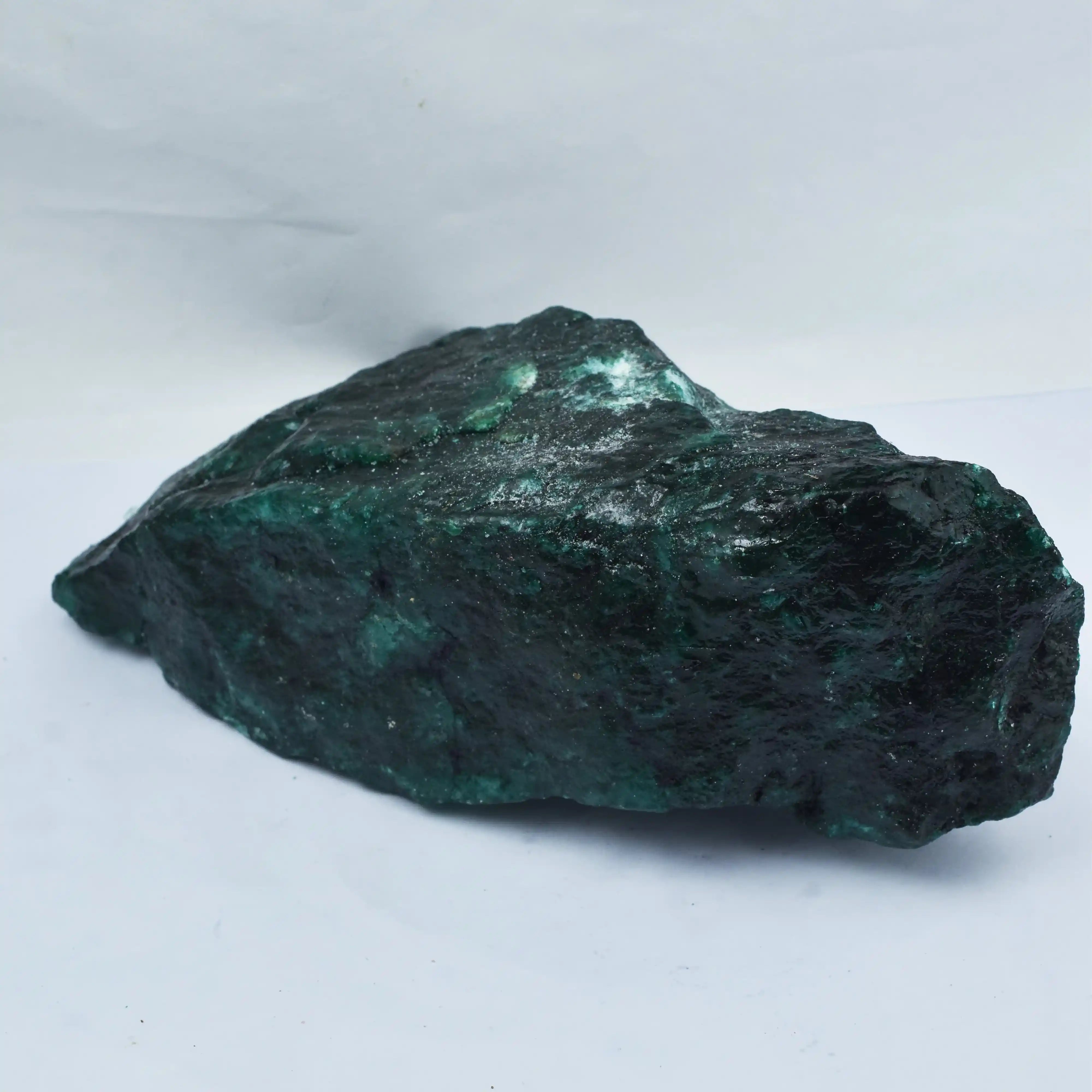 Raw emerald stone on a white background