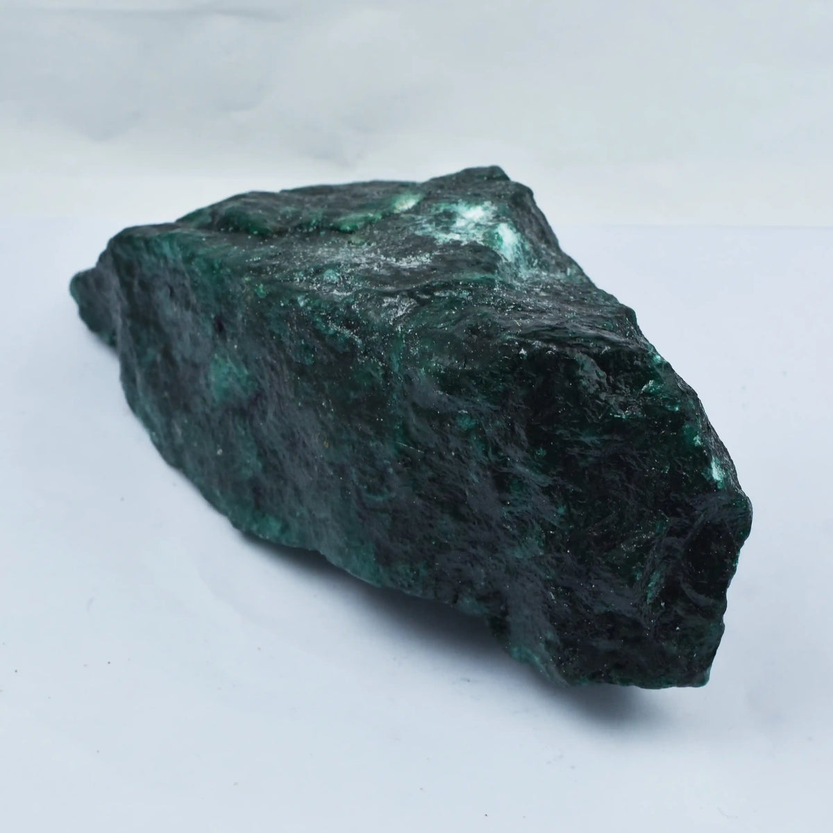 Greenish-brown mineral rock on a white background