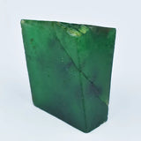 “Natural green rough stone with visible inclusions and unpolished edges.”