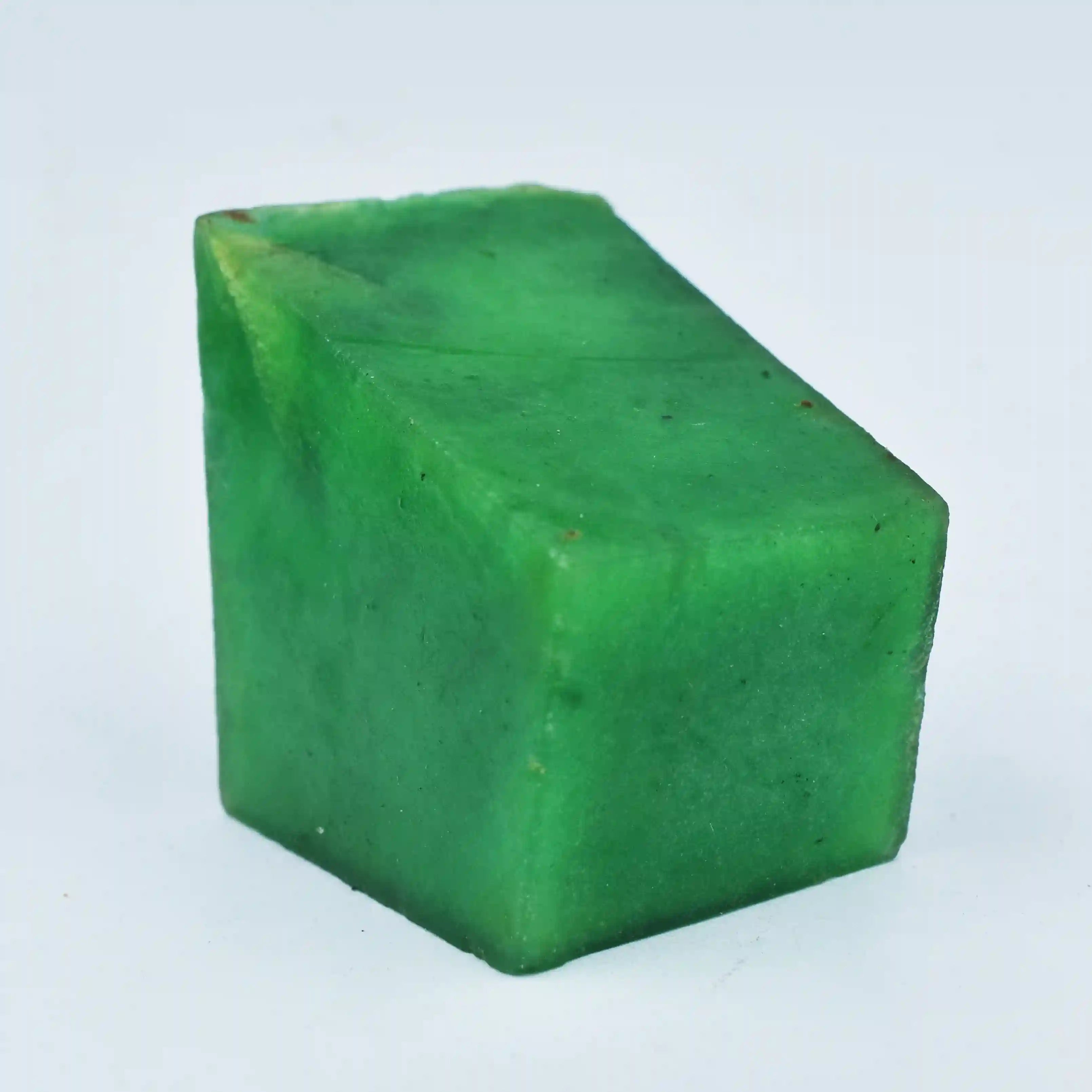 Green cube-shaped object on a light blue background