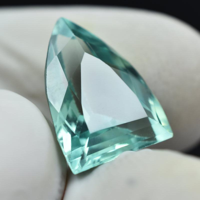 Bluish Green Montana Sapphire next to ruler showing size 13.5mm