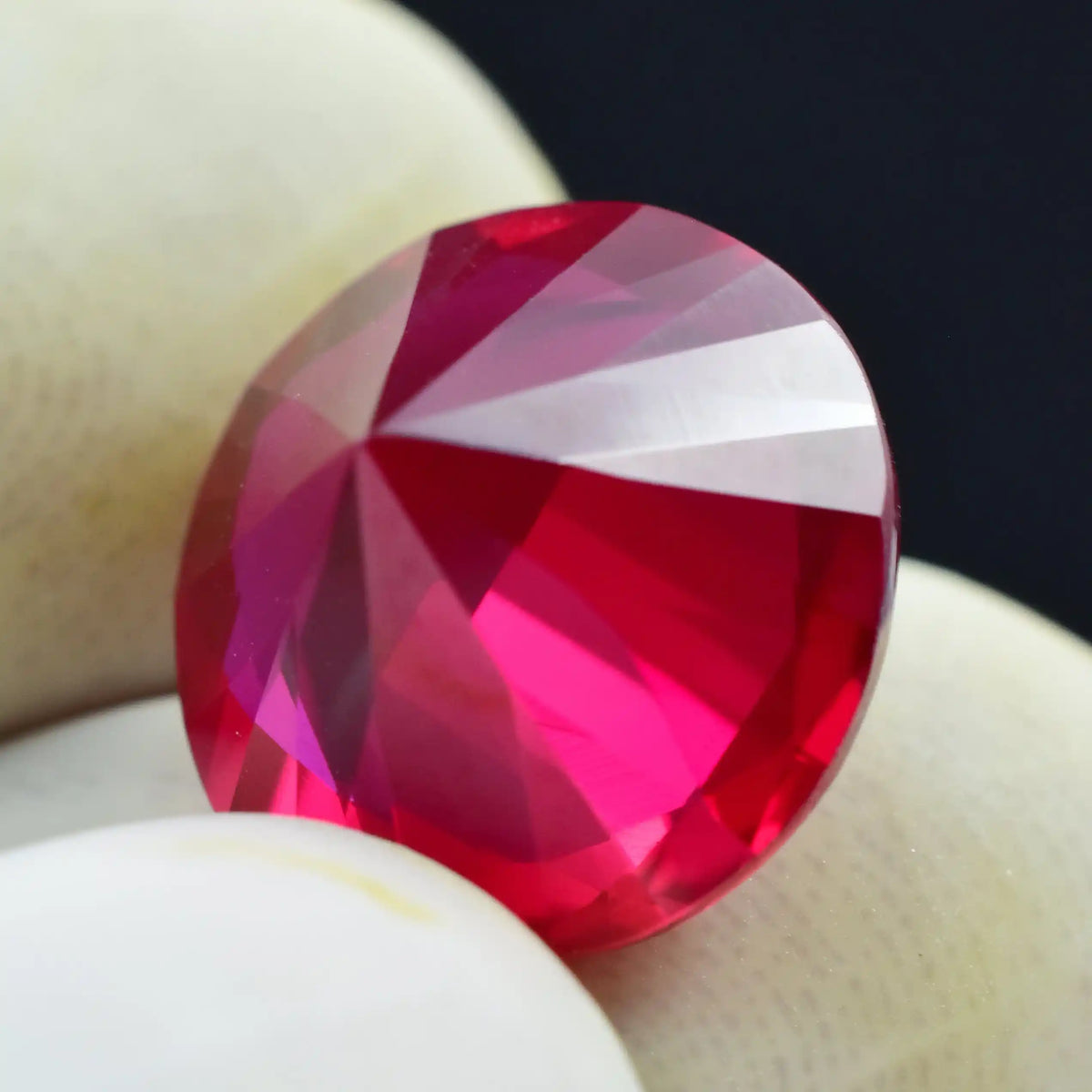 Faceted red gemstone on a white background
