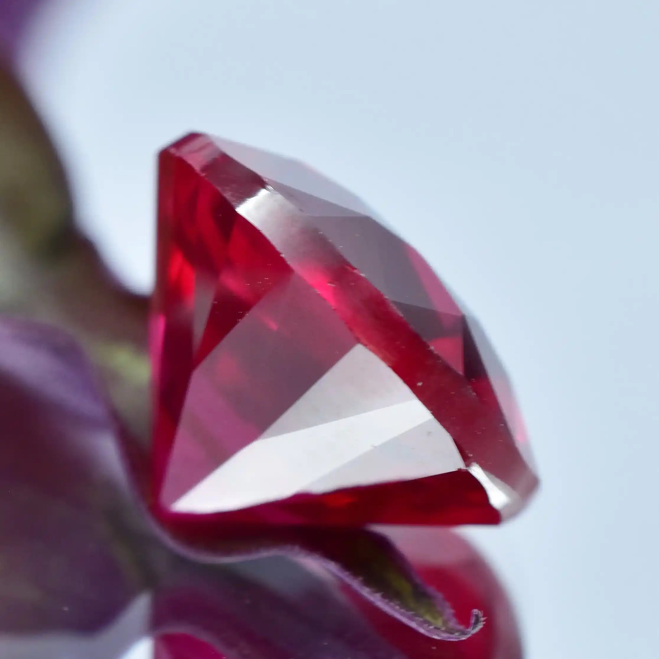 Close-up of a red gemstone with a blurred background