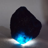 Glowing Blue Aquamarine Raw Rough Stone Under Light