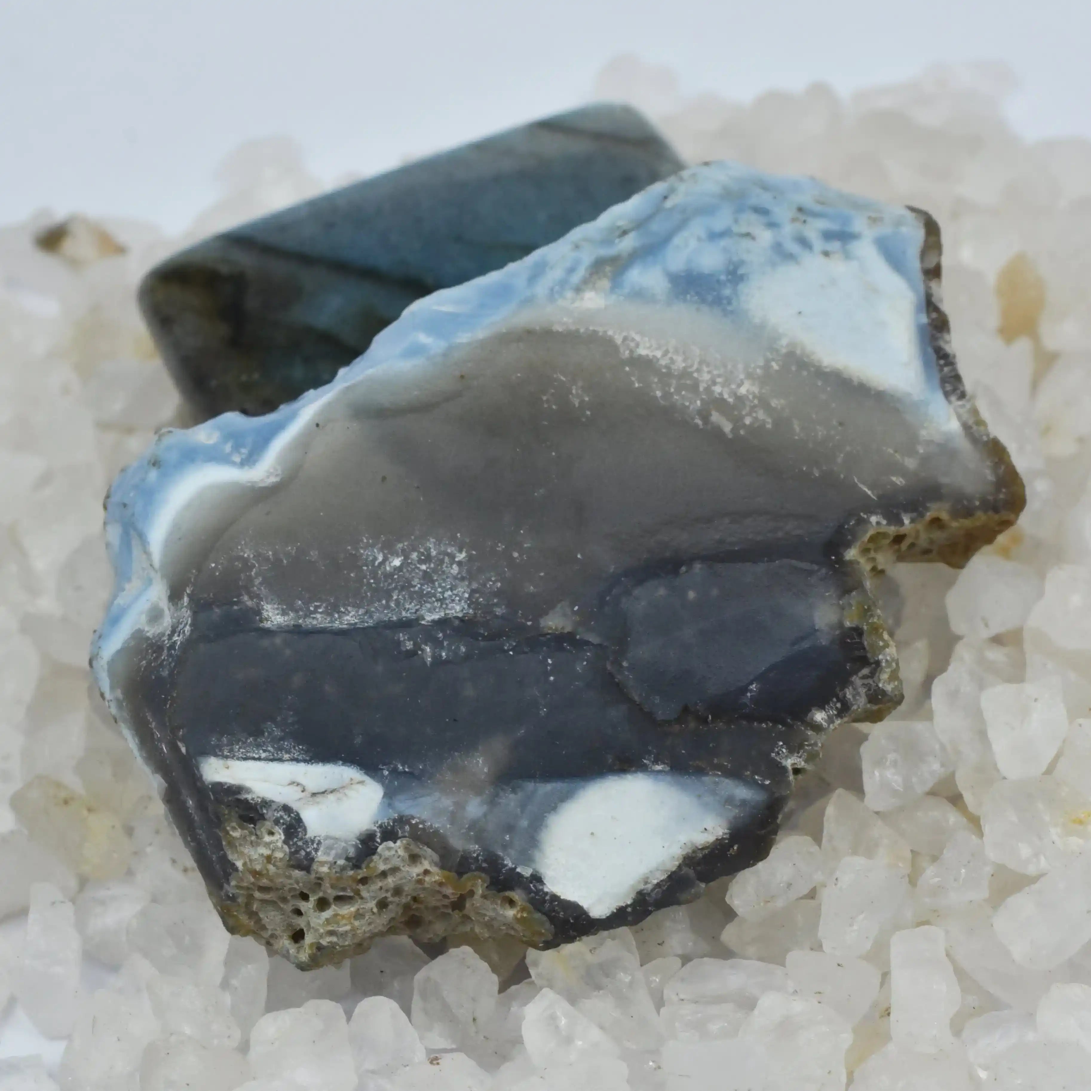 Mineral sample with blue and gray colors on a white background