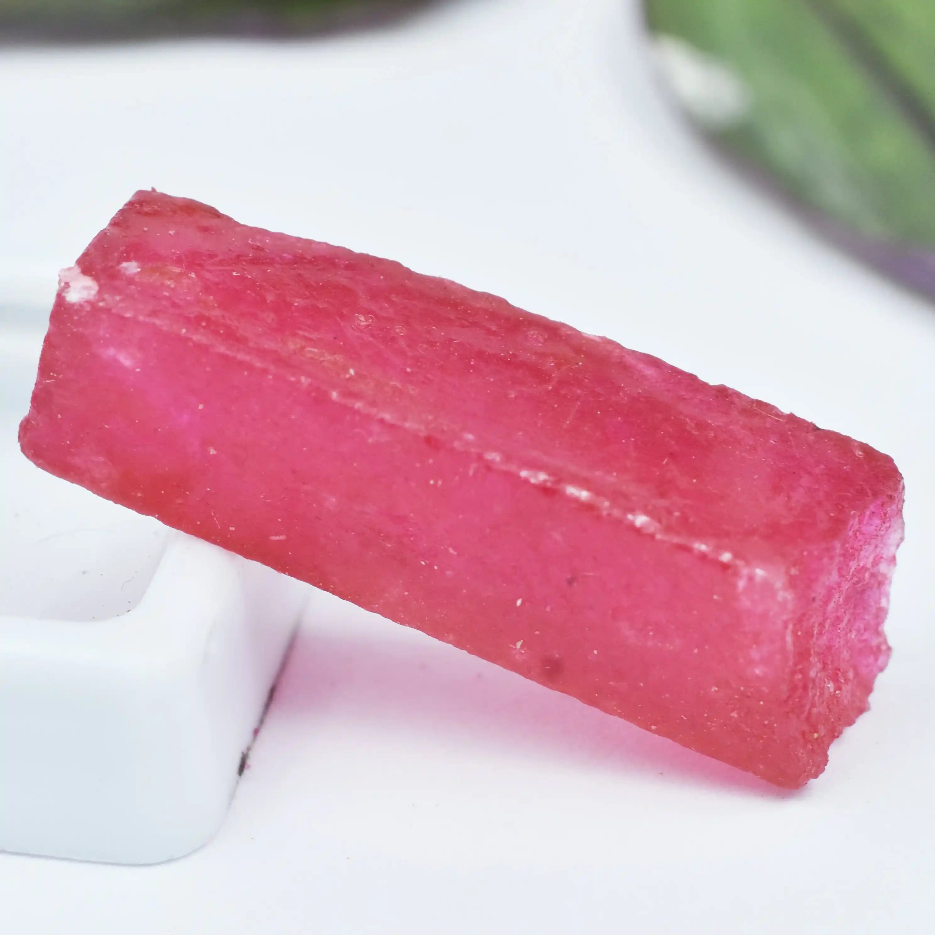 Pink gummy candy on a white surface