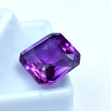 Faceted purple gemstone on a white background