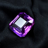 Purple gemstone on a black fabric background