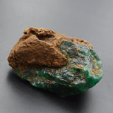 green emerald rough gemstone close up texture