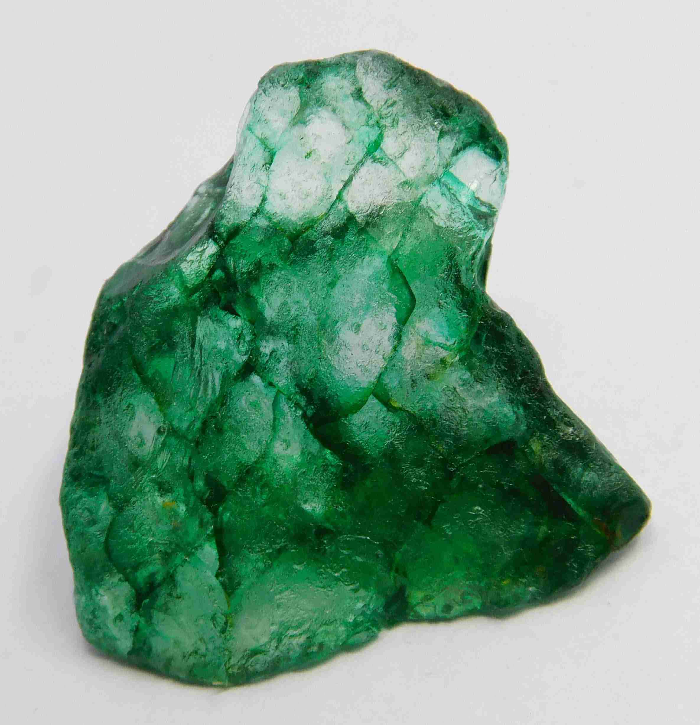 “Natural green mineral specimen with visible fractures and organic texture.”