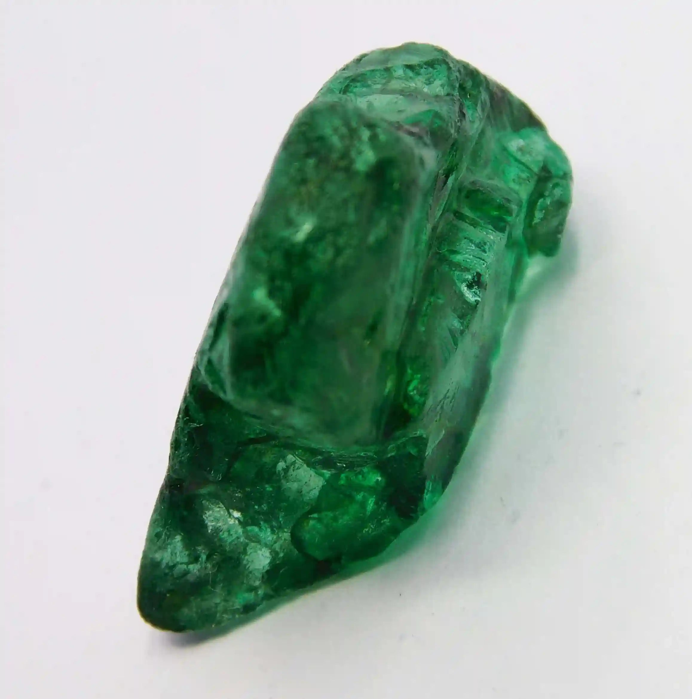“Unpolished green gemstone displaying raw formations and rich color variations.”