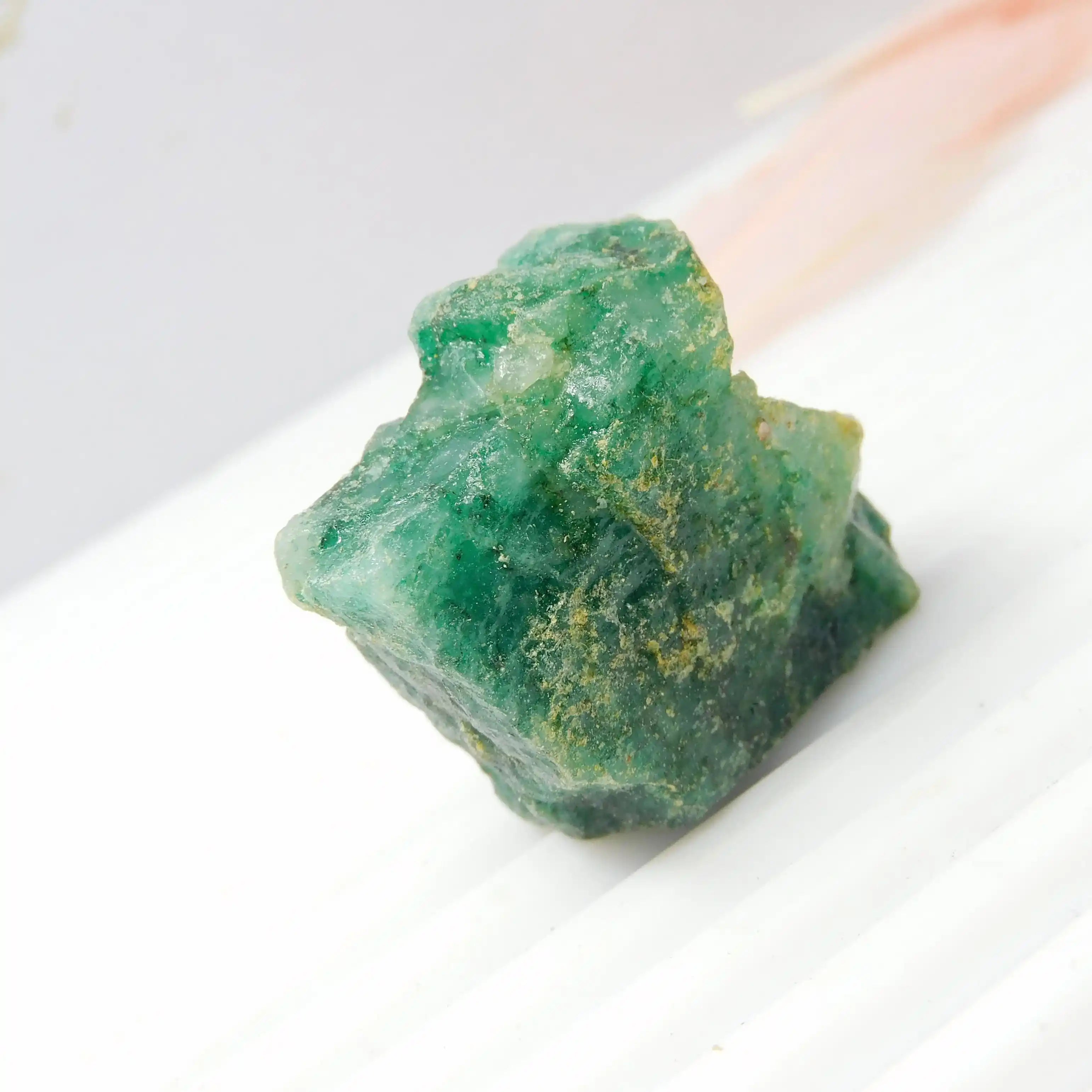 Premium natural green gemstone rough mineral stone with natural imperfections and raw rocky texture.