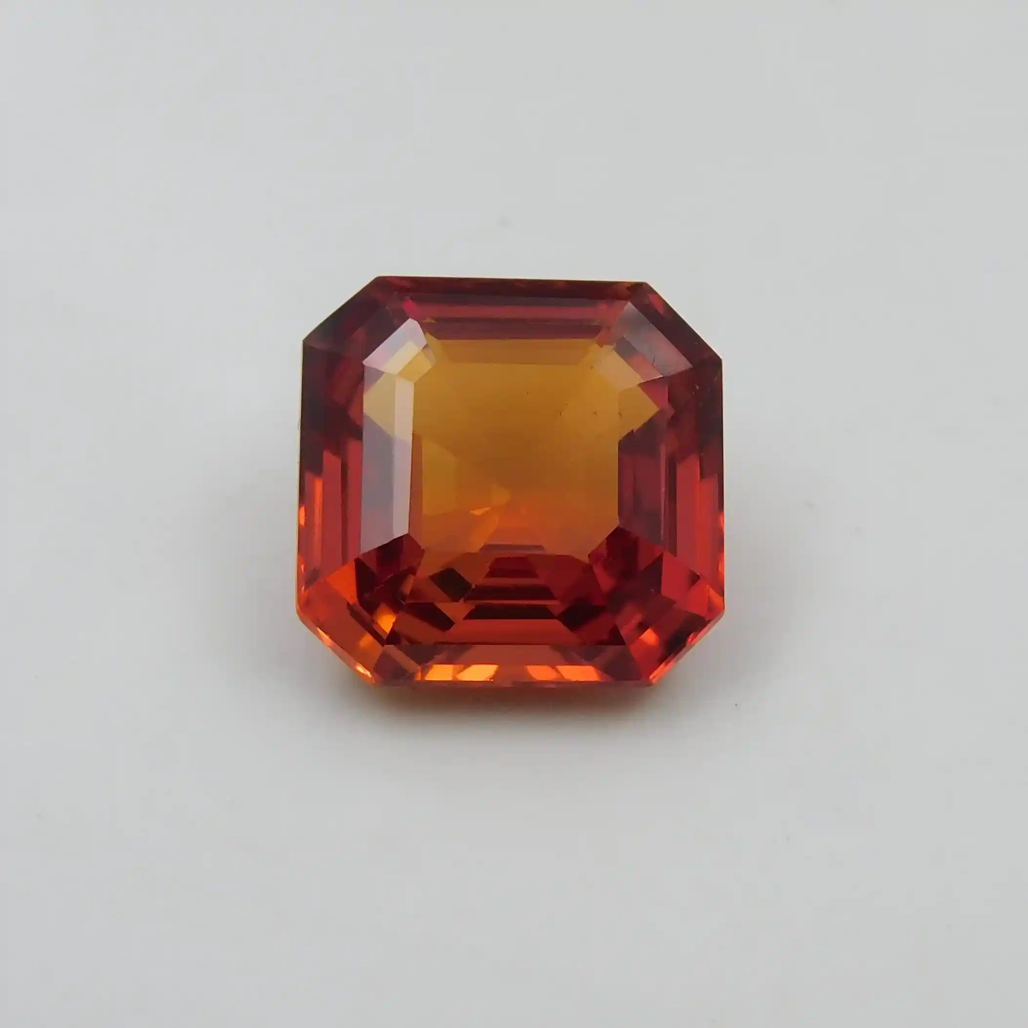 Octagonal red gemstone on a light gray background