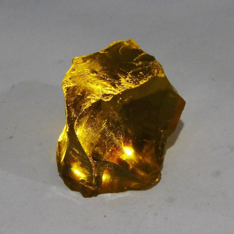 Brazilian Yellow Rough Lemon Topaz held in hand product shot
