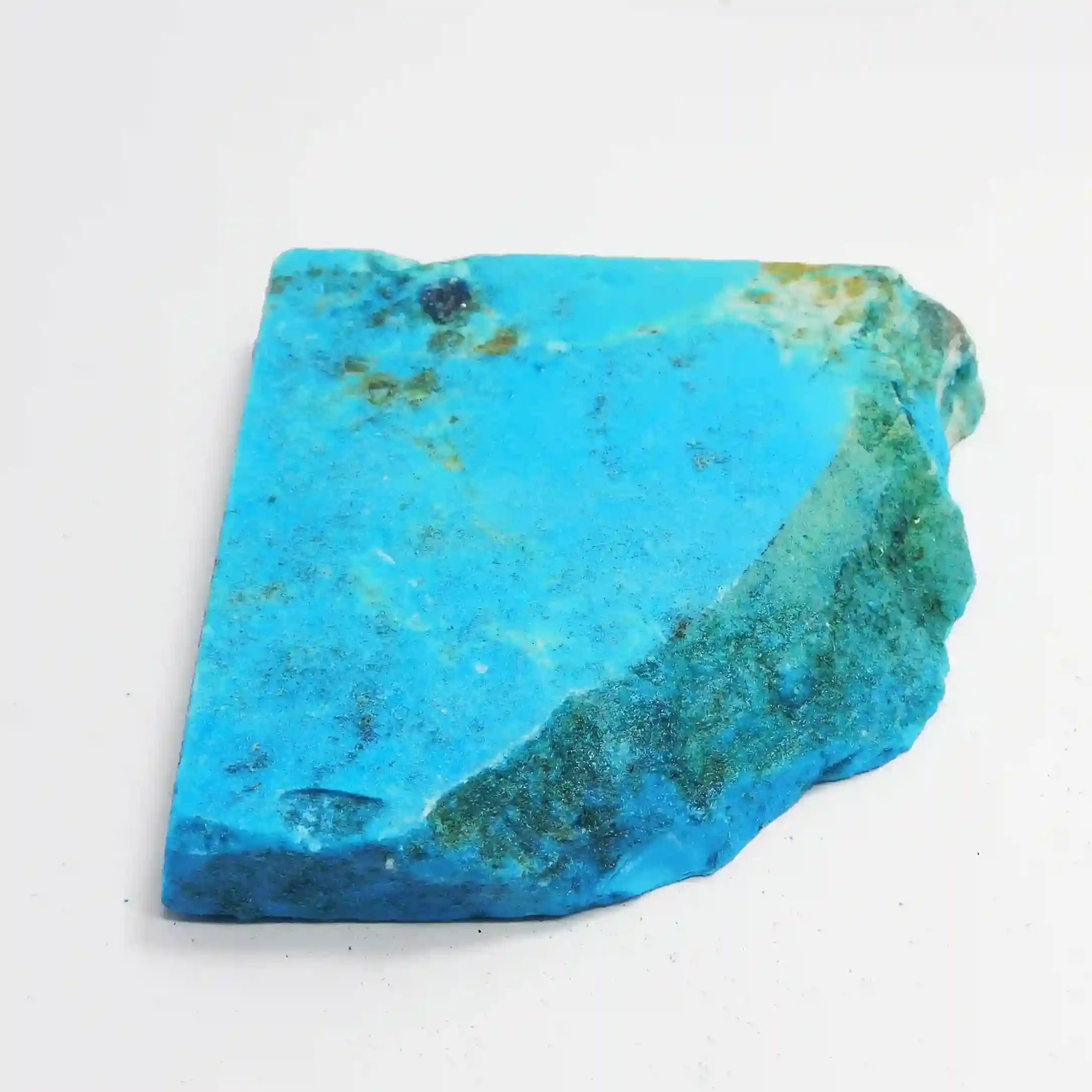 “Turquoise stone slice featuring mixed blue tones and organic brown patches.”