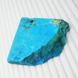 “Rough-cut turquoise gemstone showcasing vibrant blue color and earthy inclusions.”