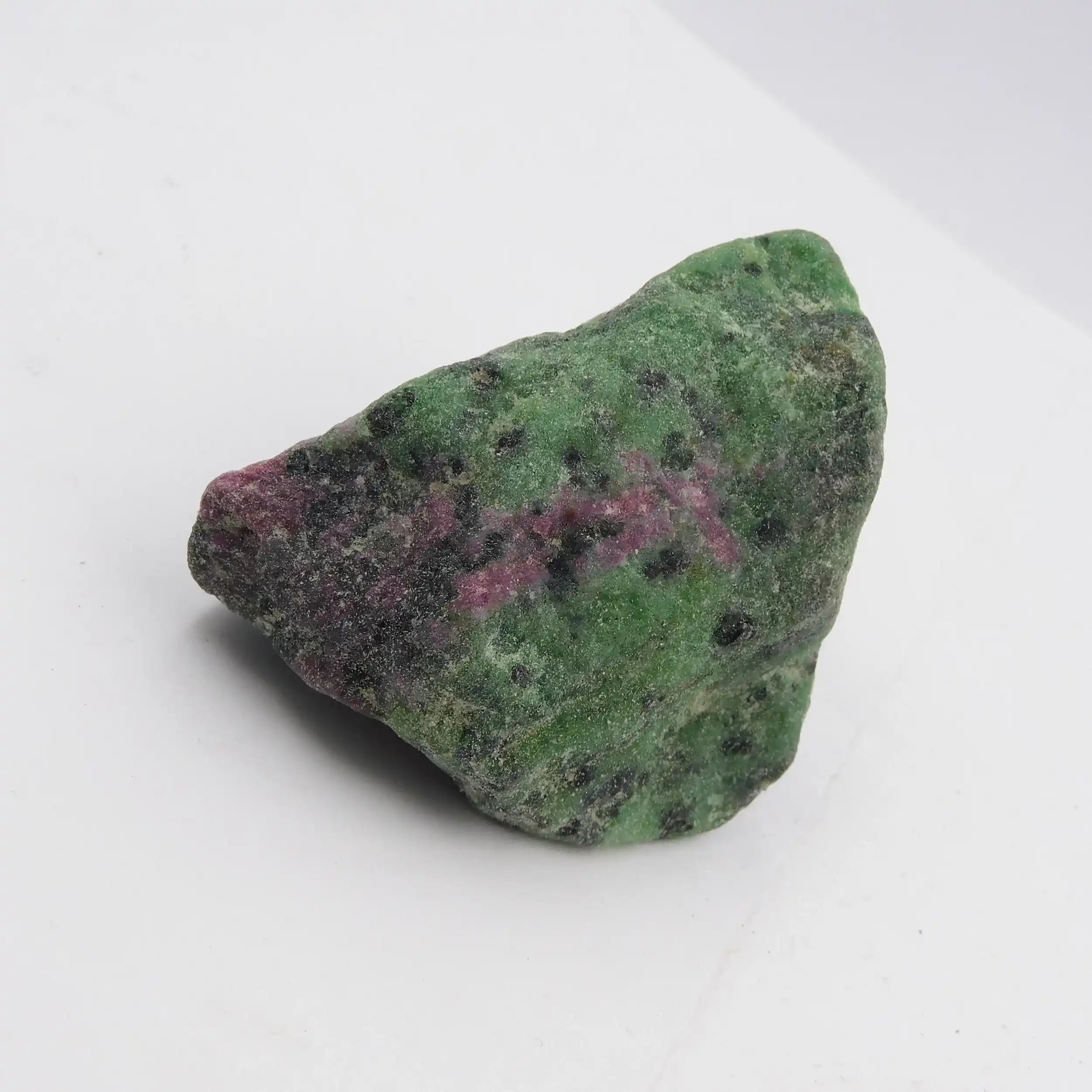 Green and purple mineral stone on a white background