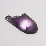 Purple crystal on a light gray background