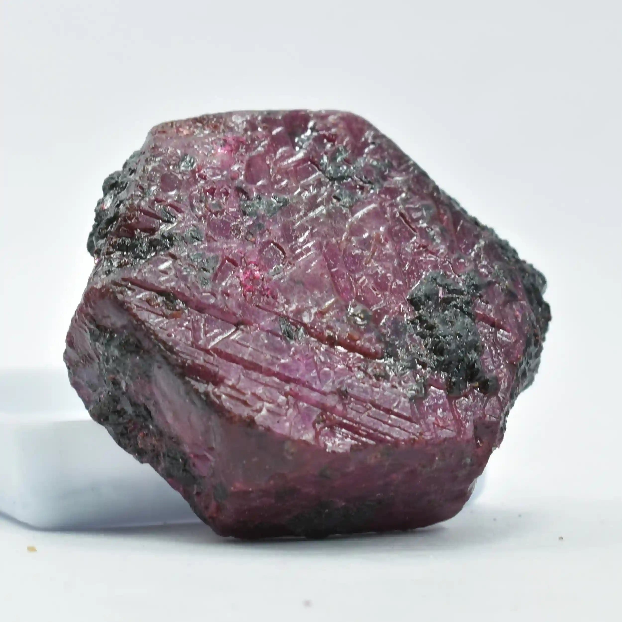 Raw ruby crystal on a white background
