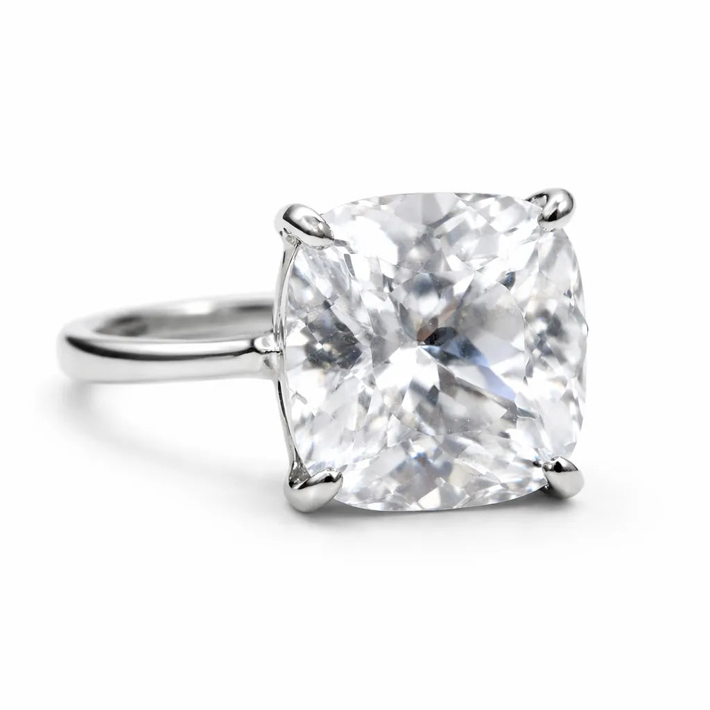 Diamond ring with a cushion-cut gemstone on a white background
