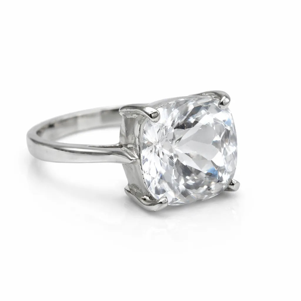 Silver ring with a large clear gemstone on a white background