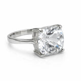 Silver ring with a large clear gemstone on a white background