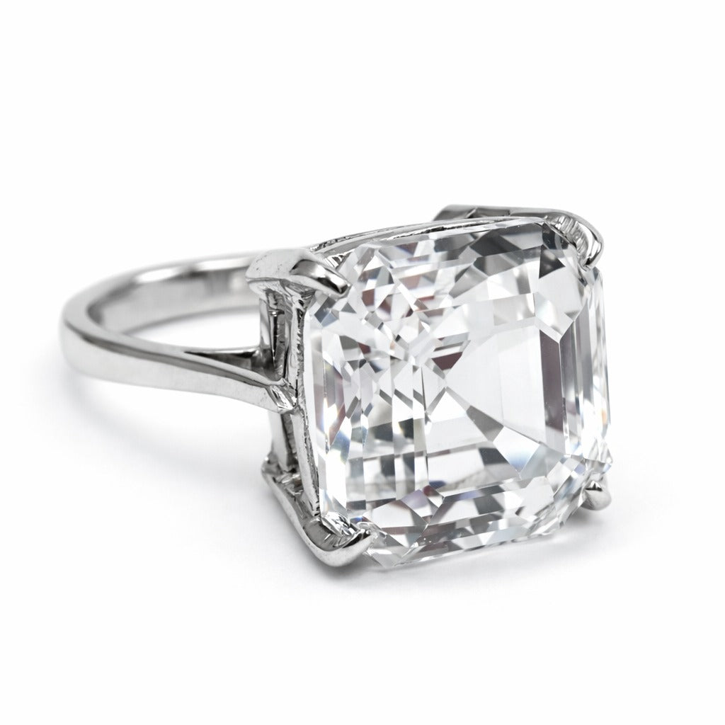 Diamond ring with a large, clear gemstone on a white background