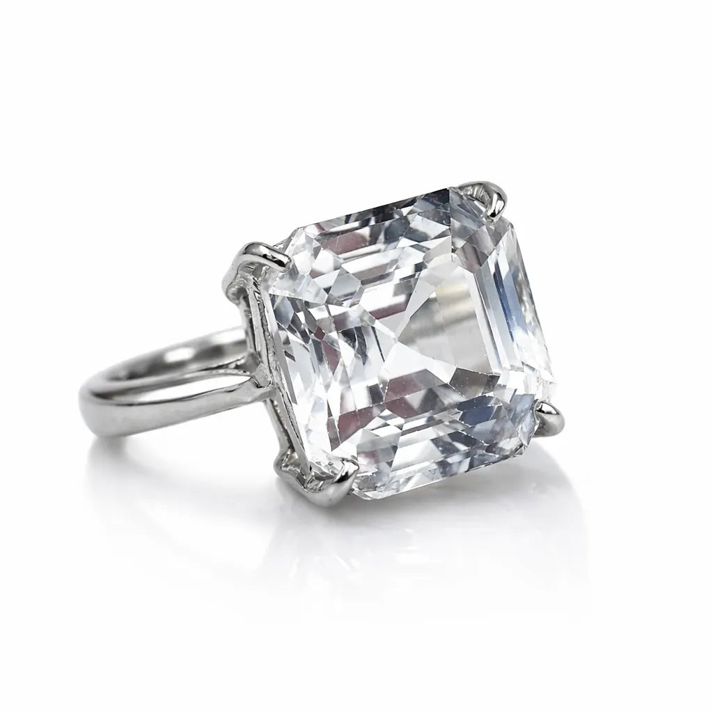 Diamond ring with a large, clear gemstone on a white background