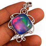 Multicolored gemstone pendant held between fingers