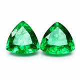 Two green gemstones with a white background