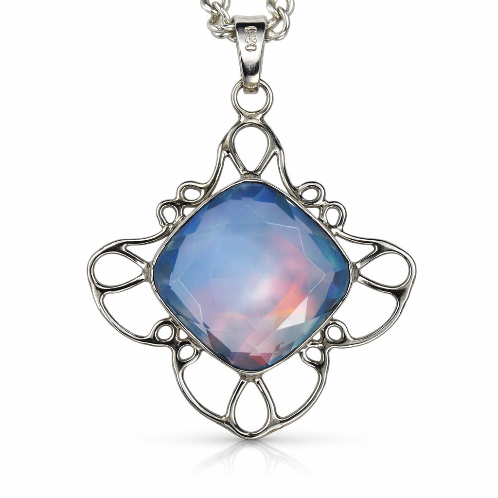 Silver pendant with a blue gemstone on a white background