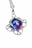 Silver pendant with a colorful gemstone on a white background