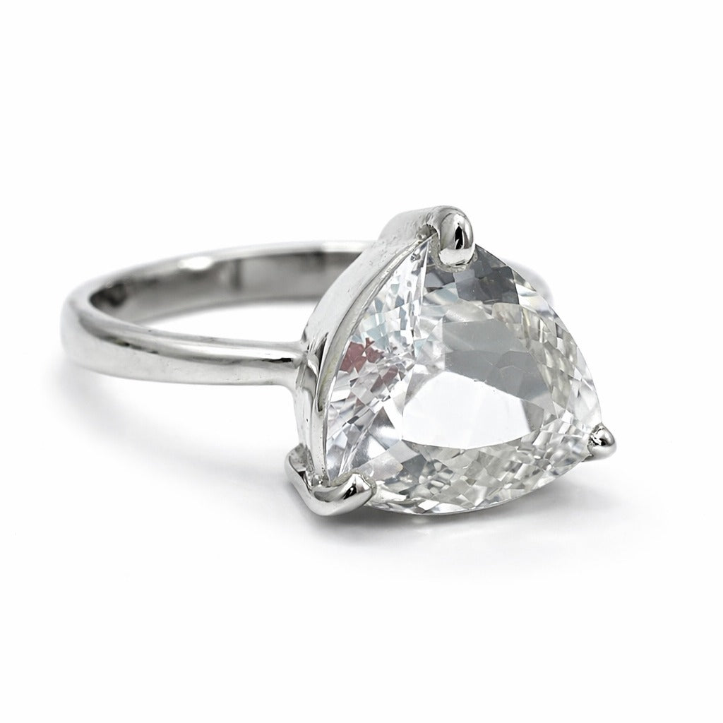 Silver ring with a large clear gemstone on a white background