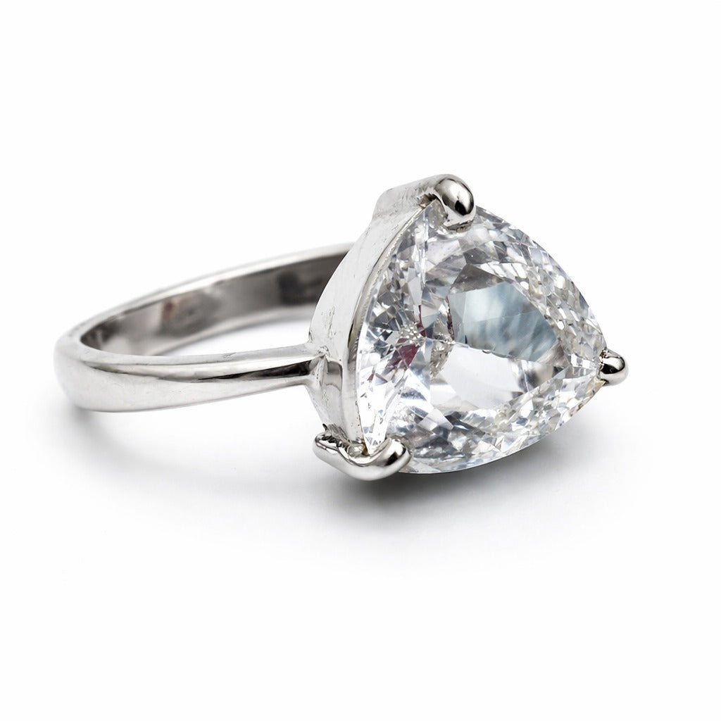 Silver ring with a large clear gemstone on a white background